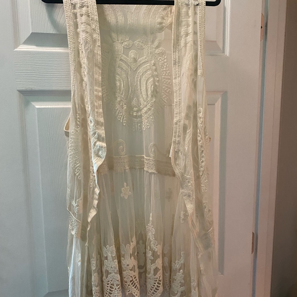 Cream Asymmetrical Ruffled Sleeveless Blouse
